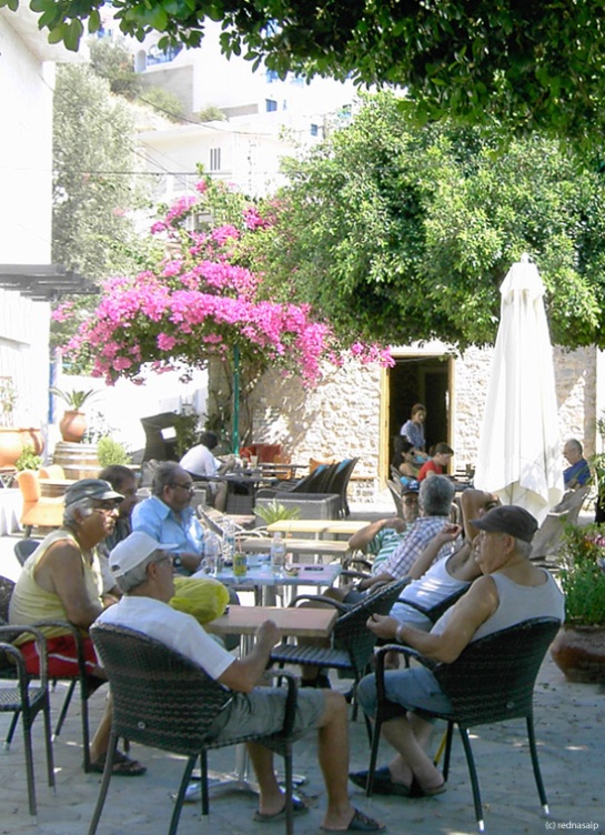 The bus to Plaka Beach leaves from the center of Livadia where the locals meet under the shady trees of the kafenion