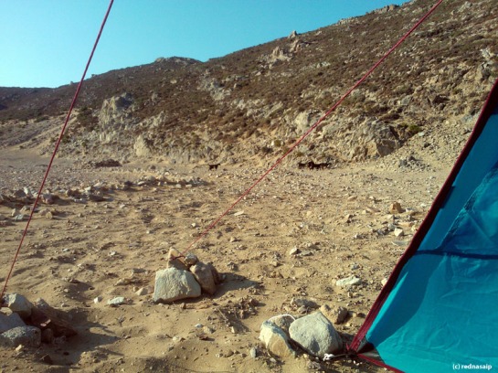 Camping on Psili Ammos, Patmos, can be a bit challenging when the wind decides to play with your tent. You absolutely need big heavy rocks to keep your plugs in the sand in place.